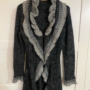 Boutique sweater . Grey and black with ruffles .